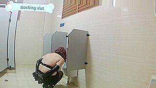Japanese slut bonds self in public toilet, teases.