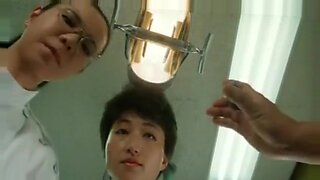 Asian patient gets examined by dentist
