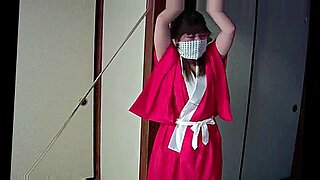 Japanese beauty endures intense bondage and gagging in captivating BDSM scene.