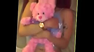 Shy teen hug her teddy bear while m ast urb at