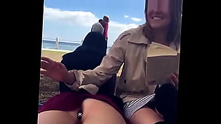 Girls engage in lesbian activities on the beach